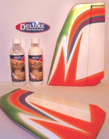 Decorative foam sheets with a colorful design next to bottles of 'Clear Kote' on a white background, featuring the Deluxe Materials logo.