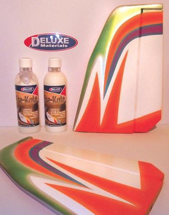 Decorative foam sheets with a colorful design next to bottles of 'Clear Kote' on a white background, featuring the Deluxe Materials logo.