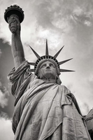 Black and white photo of the Statue of Liberty against a cloudy sky