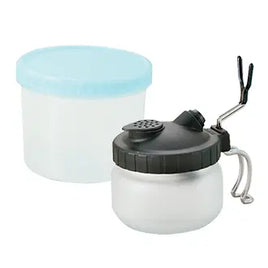 White container with black lid and blue cap on a white background