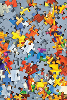 Colorful puzzle pieces scattered on a gray background