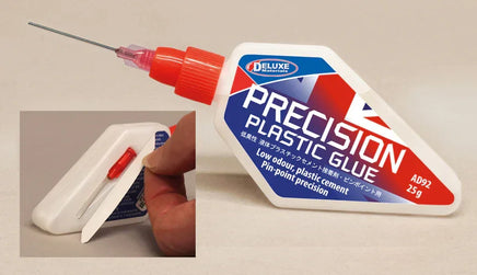 Precision plastic glue container with a syringe on a beige background
