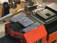 Close-up of a toy train with detailed components on a blurred background