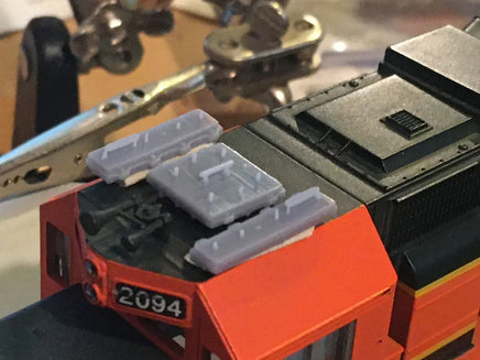 Close-up of a toy train with detailed components on a blurred background