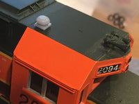 Model train with orange front and black top, featuring the number 2094.