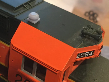 Model train with orange front and black top, featuring the number 2094.