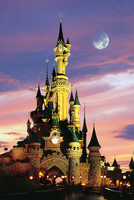 Fantasy castle with illuminated towers against a colorful sunset sky