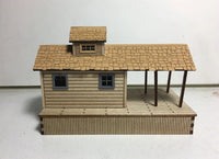 Model of a two-story house with a small porch on a white background