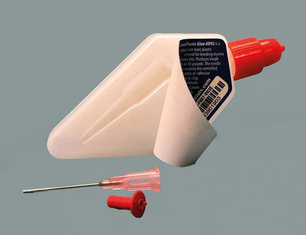 Glue gun with a separate needle on a gray background