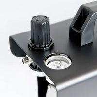 Close-up of a metal bracket with a knob and cylindrical component on a white background