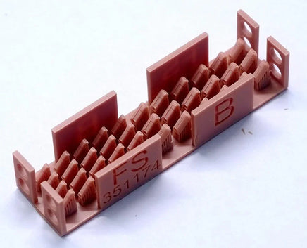 Red plastic model kit with lettering on a white background