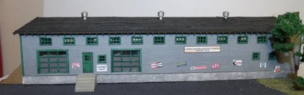 Model of a building with various signs and a plant on a white background