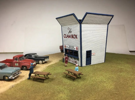 Model of a clam shack with people and cars in front, set against a plain background