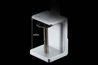 Small white device with a metallic component on a black background