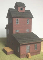 Model of a two-story building with a red brick facade and gray roof on a plain background.