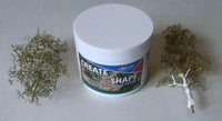 Container of modeling clay with two small sculptures on a plain background