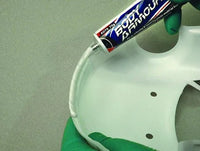 Hand applying a tube of poly bannown to a white wheel rim.
