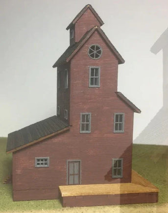 Model of a red brick building with a clock tower on a white background