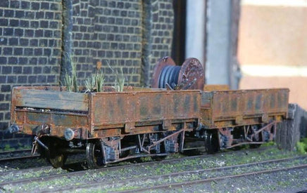 Model train car with rusted appearance on a track