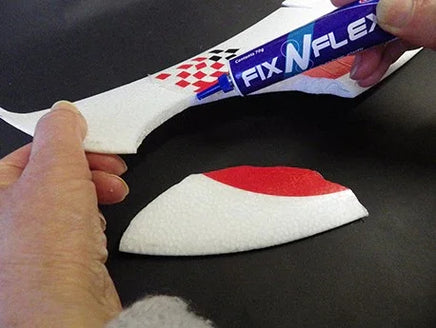 Person applying FixNFLex product to a white shoe on a black background