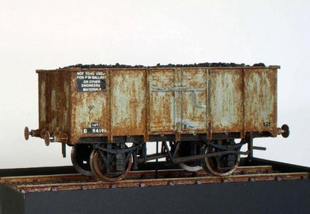 Rust-covered model railway wagon on a white background