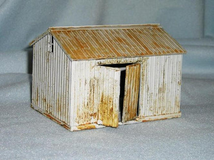 Model of a rustic shed with corrugated metal siding on a gray background