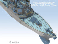 Model of a US Navy guided missile destroyer on a light blue background