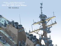 Model of a US Navy guided missile destroyer with detailed superstructure on a light blue background.