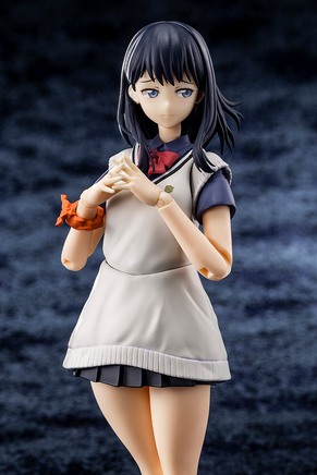 Figure of a character in a school uniform with a blurred dark background